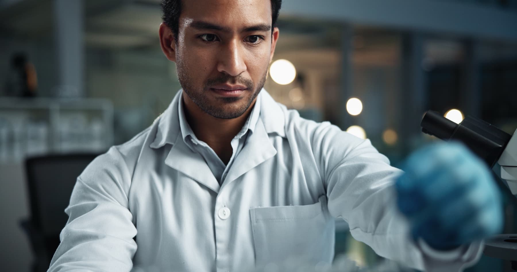 Researcher at a microscope